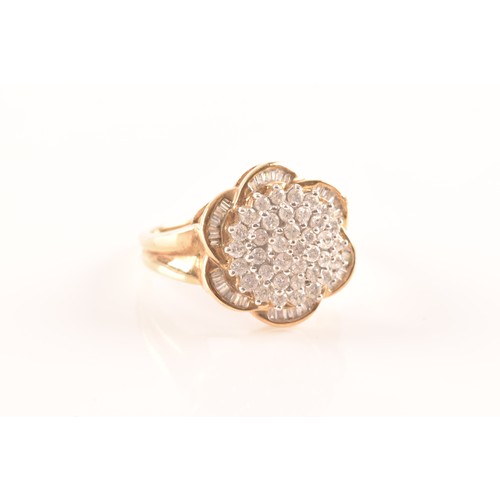 55 - A 9ct yellow gold diamond flower cluster ring, featuring a myriad of brilliant cut diamonds, further... 