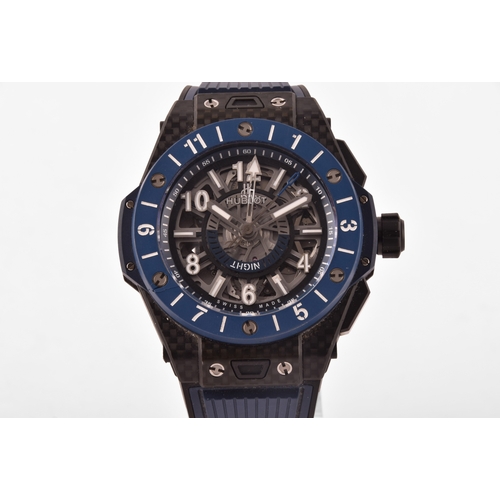 A Hublot Big Bang Unico GMT carbon fibre blue ceramic wristwatch, the blue skeleton dial with, self-winding chronograph flyback movement with column wheel, case size 42 mm, on a blue rubber strap with titanium deployant buckle clasp.
