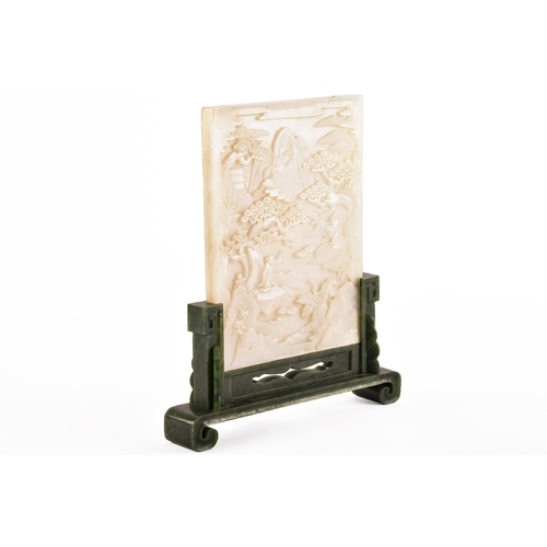 A Chinese Qing Dynasty carved jade table screen, carved with landscapes and figures, set on a jade stand, 10 cm high including stand. 