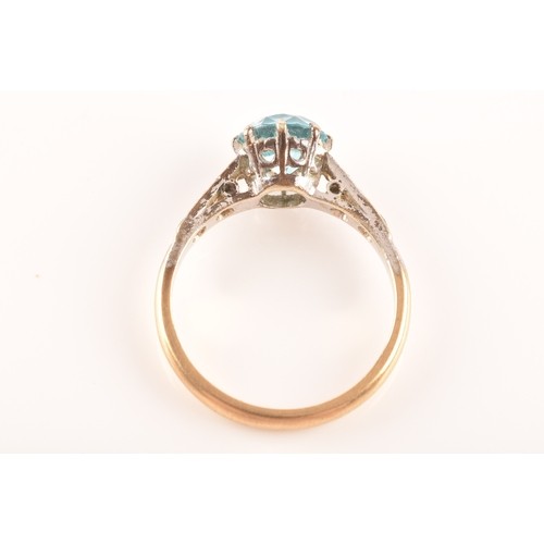 15 - An 9ct yellow gold and white metal solitaire ring, set to centre with a round cut zircon with an app... 