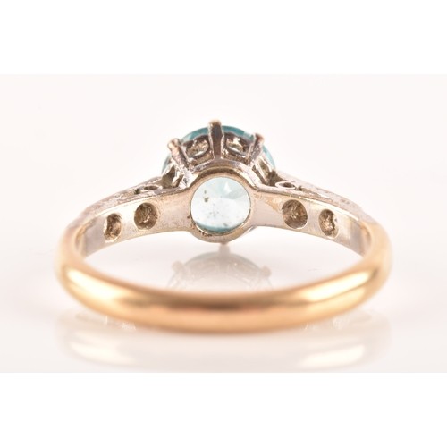 15 - An 9ct yellow gold and white metal solitaire ring, set to centre with a round cut zircon with an app... 