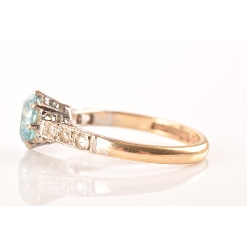 15 - An 9ct yellow gold and white metal solitaire ring, set to centre with a round cut zircon with an app... 