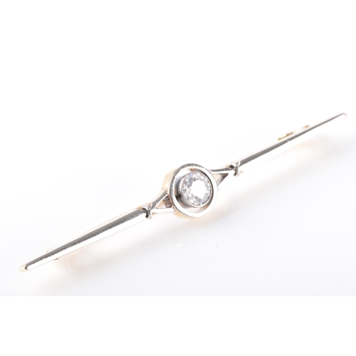 29 - A yellow and white gold and diamond bar brooch, set to centre with a round brilliant cut diamond wit... 