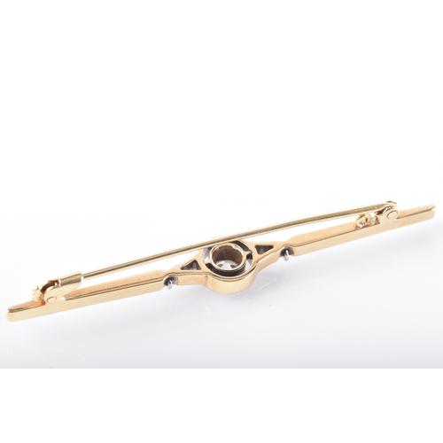 29 - A yellow and white gold and diamond bar brooch, set to centre with a round brilliant cut diamond wit... 