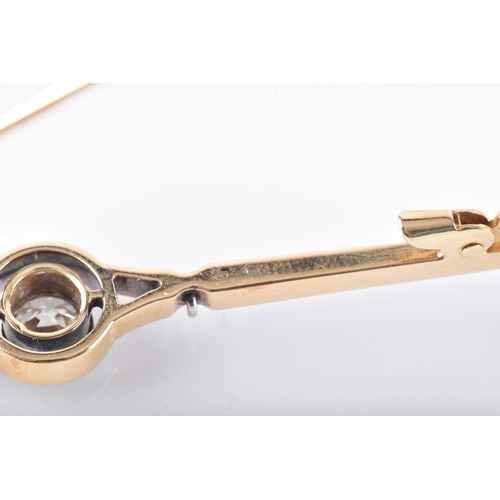 29 - A yellow and white gold and diamond bar brooch, set to centre with a round brilliant cut diamond wit... 