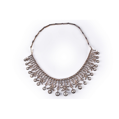 An exceptional 19th century diamond necklace/tiara, featuring 204 mixed shape rose cut diamonds with a total approximate weight of 15 carats, the central largest diamond with an approximate weight of 1.15 carats, featuring two rows of rose cut diamonds in closed back raised claw settings, further set with a myriad of rose cut diamonds in drop shape floral forms, in gilt metal settings, on a rectangular link chain set with 14 rubies, with removable hook fastening to covert into a tiara, approximately 43 cm long.