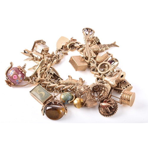 A 9ct yellow gold charm bracelet, suspended with over 25 gold charms.