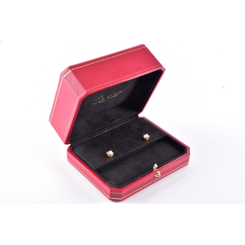 Cartier. A pair of C de Cartier 18ct yellow gold diamond stud earrings, featuring two round brilliant cut diamonds each with a weight of 0.50 carats, D colour, VVS2 clarity, 1.00 carat in total, with push back fittings, in original presentation box, accompanied by two GIA Certificates no.7122296354 and no.6137318867, and certificate of authenticity. Serial no.TB8O53.