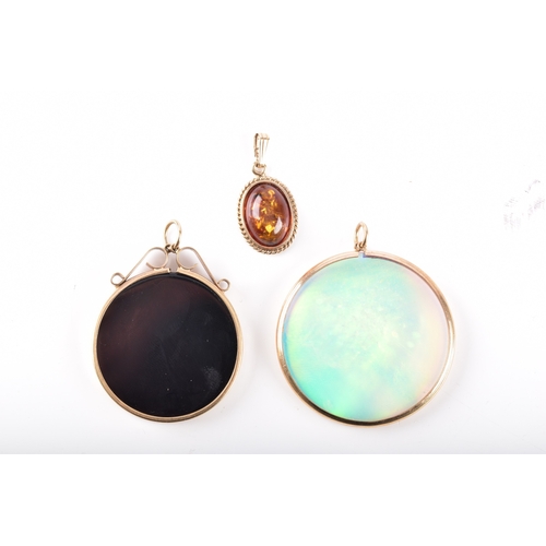70 - Three pendants, including a 9ct hologram pendant in a 9ct yellow gold mount and bale, 4 cm diameter,... 