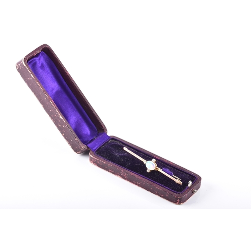 65 - A 9ct yellow gold opal and diamond brooch, set with an oval cabochon opal measuring approximately 8.... 