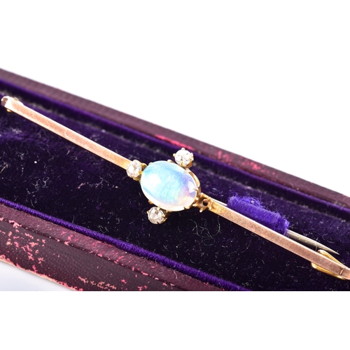 65 - A 9ct yellow gold opal and diamond brooch, set with an oval cabochon opal measuring approximately 8.... 