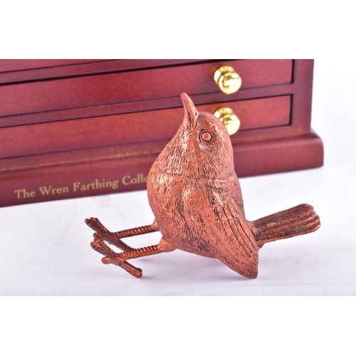 109 - A small collection of silver coins and farthings, twenty in total, housed in a miniature set of coll... 