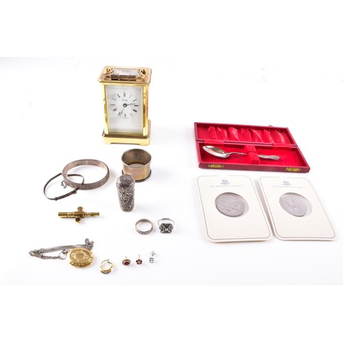 212 - A Henley gilt carriage clock with key, 11 cm high, two commemorative crowns, a silver engraved bangl... 