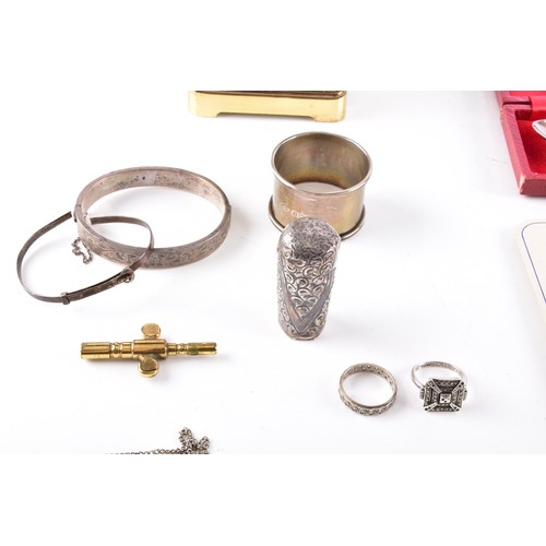 212 - A Henley gilt carriage clock with key, 11 cm high, two commemorative crowns, a silver engraved bangl... 