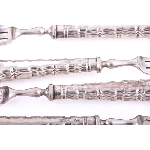 158 - A silver backed hand mirror and hair brush, with repousse decoration featuring leaves, masks, and bi... 