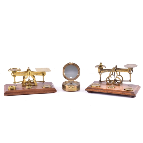 214 - Two late 19th to early 20th century brass postal balance scales, each with twin circular pans on a b... 