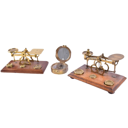 214 - Two late 19th to early 20th century brass postal balance scales, each with twin circular pans on a b... 