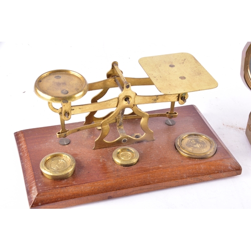 214 - Two late 19th to early 20th century brass postal balance scales, each with twin circular pans on a b... 