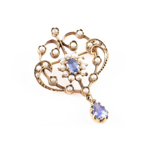 60 - A 9ct yellow gold Art Nouveau style seed pearl and blue stone brooch, featuring intricate gold work ... 