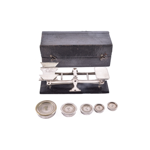 216 - A cased set of portable beam scales, the balance with twin pans and central sliding weight, housed w... 