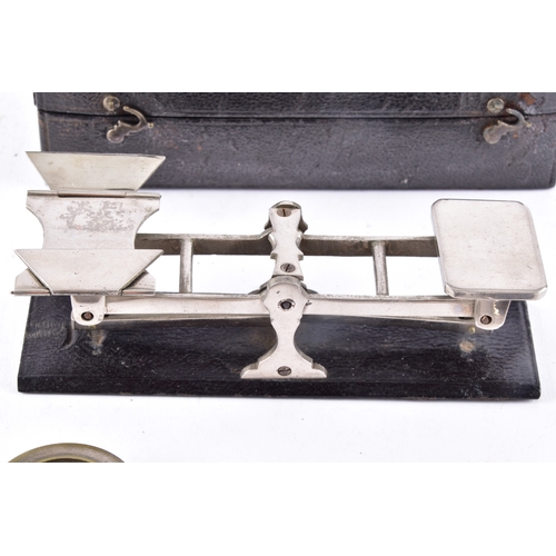 216 - A cased set of portable beam scales, the balance with twin pans and central sliding weight, housed w... 