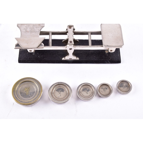216 - A cased set of portable beam scales, the balance with twin pans and central sliding weight, housed w... 
