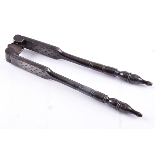 217 - A vintage brass pastry tool, a celluloid glove stretcher, together with a antique iron nut cracker. ... 