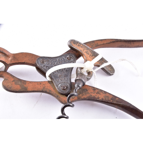 219 - A pair of champagne nippers, featuring pliers at one end to cut the wire and an integrated dusting b... 