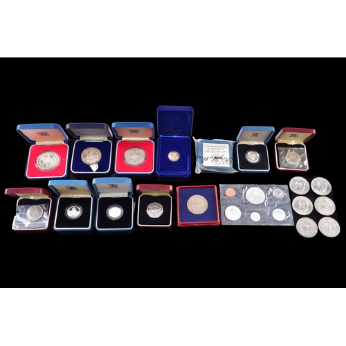 99 - A collection of coins, including four cased United Kingdom silver proof one pound coins, a cased 197... 