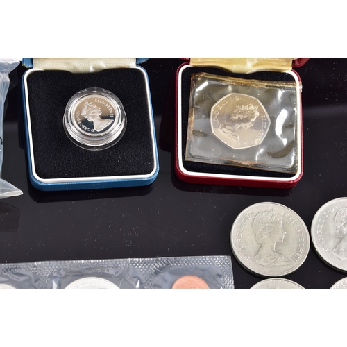 99 - A collection of coins, including four cased United Kingdom silver proof one pound coins, a cased 197... 