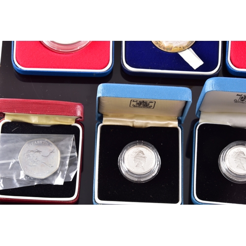 99 - A collection of coins, including four cased United Kingdom silver proof one pound coins, a cased 197... 
