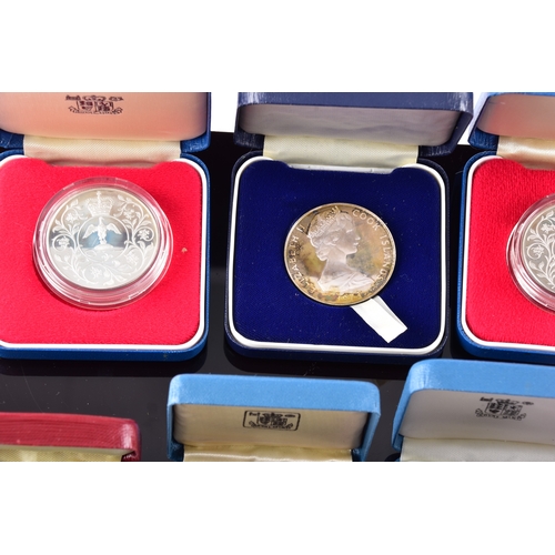 99 - A collection of coins, including four cased United Kingdom silver proof one pound coins, a cased 197... 