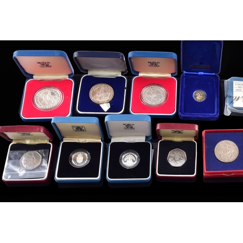 99 - A collection of coins, including four cased United Kingdom silver proof one pound coins, a cased 197... 