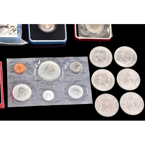 99 - A collection of coins, including four cased United Kingdom silver proof one pound coins, a cased 197... 