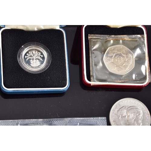 99 - A collection of coins, including four cased United Kingdom silver proof one pound coins, a cased 197... 