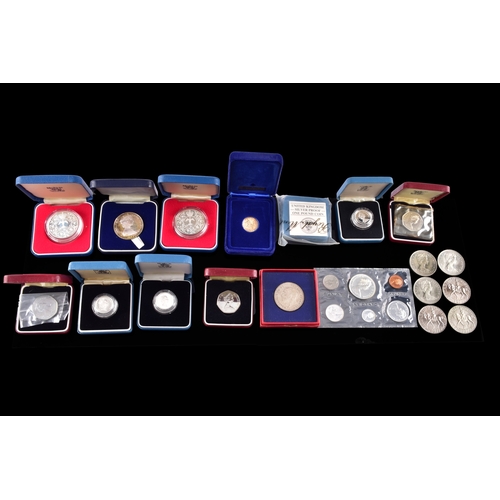 99 - A collection of coins, including four cased United Kingdom silver proof one pound coins, a cased 197... 