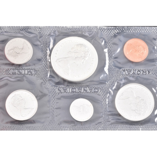 99 - A collection of coins, including four cased United Kingdom silver proof one pound coins, a cased 197... 