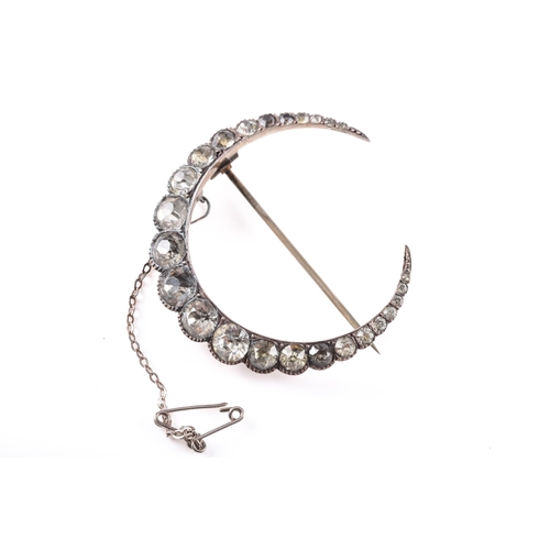 73 - A 900 silver crescent moon paste brooch, 4.4 cm long, fitted with pin and safety chain, in a vintage... 