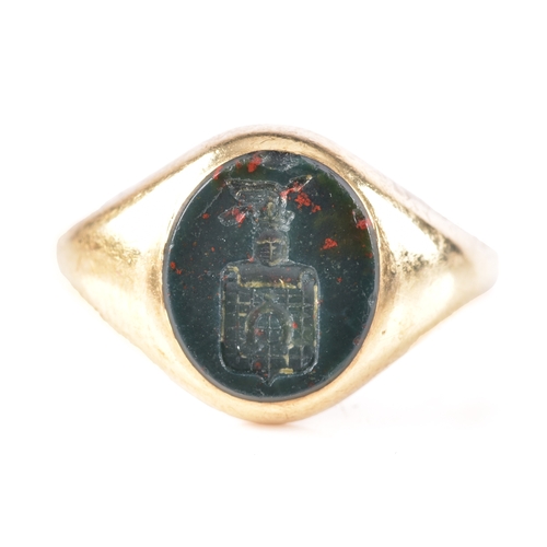 75 - A 9ct yellow gold bloodstone intaglio set signet ring, featuring a carved heraldic crest, hallmarked... 
