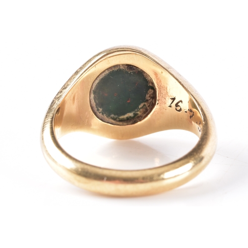 75 - A 9ct yellow gold bloodstone intaglio set signet ring, featuring a carved heraldic crest, hallmarked... 