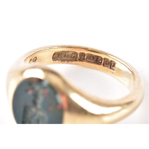 75 - A 9ct yellow gold bloodstone intaglio set signet ring, featuring a carved heraldic crest, hallmarked... 