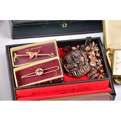 48 - A large collection of costume jewellery, cufflinks, brooches, watches, tie clips, travel clocks, nec... 