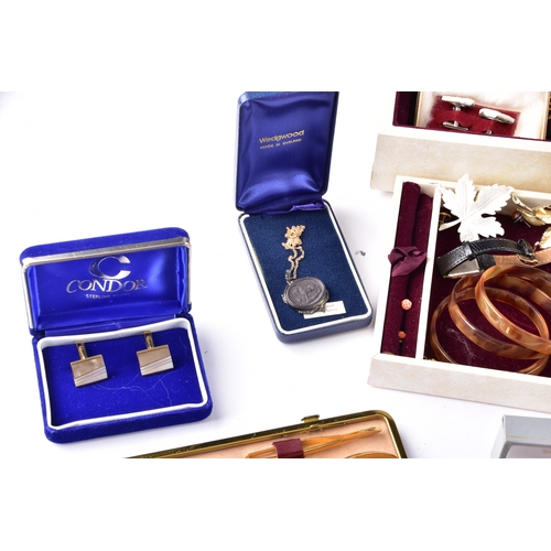 48 - A large collection of costume jewellery, cufflinks, brooches, watches, tie clips, travel clocks, nec... 