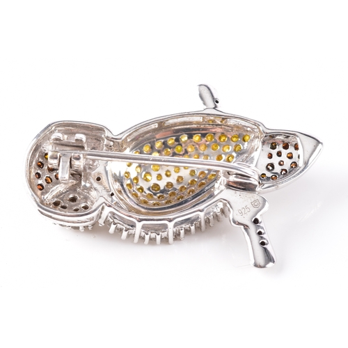 22 - A 925 silver and diamond owl brooch, featuring a myriad of treated fancy diamonds, 3.3 cm long, fitt... 