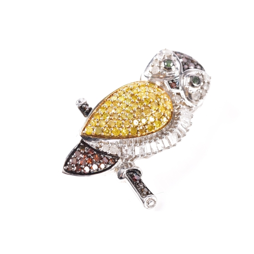 22 - A 925 silver and diamond owl brooch, featuring a myriad of treated fancy diamonds, 3.3 cm long, fitt... 