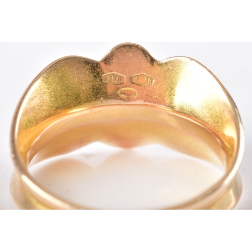 26 - An 18ct yellow and white gold ruby ring, of abstract design, set with four round rubies (missing a s... 