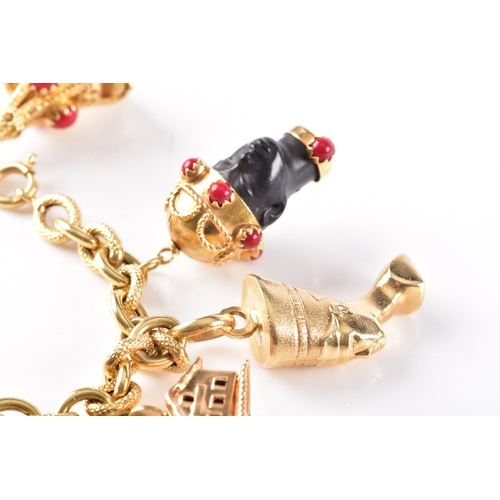 27 - An 18ct yellow gold charm bracelet, with alternating smooth and textured links, suspended with nine ... 