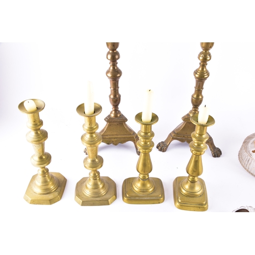 342 - A collection of decorative arts including a pair of large brass altar candlesticks, with turned stem... 