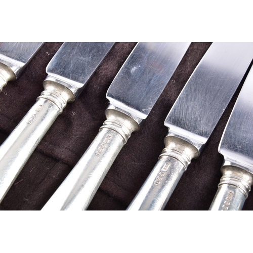 188 - A large collection of silver handled knives, including twenty-four tapered silver handled table kniv... 