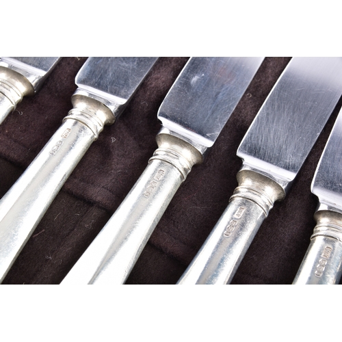 188 - A large collection of silver handled knives, including twenty-four tapered silver handled table kniv... 